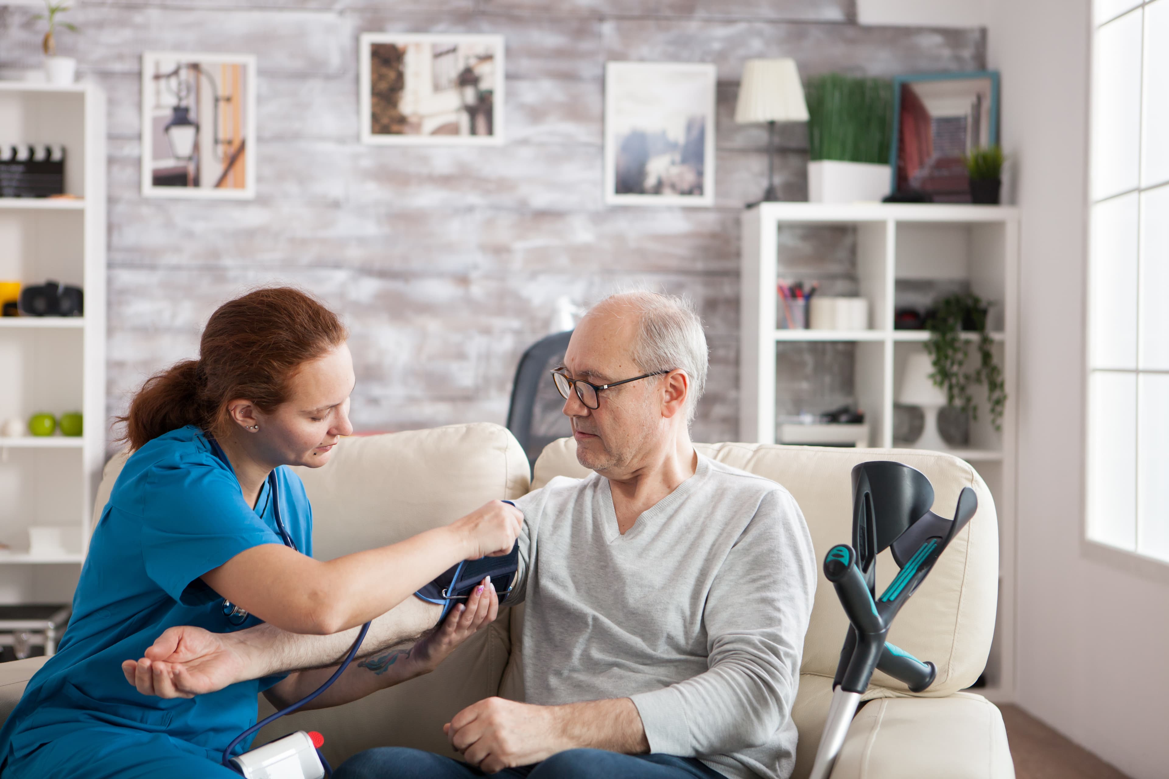 Nurse checking a patient's blood pressure at home